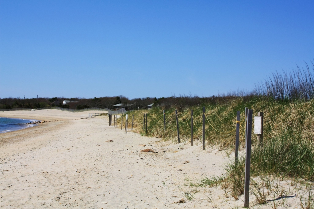 Menauhant Beach in Falmouth, MA with Stage Harbor Lighthouse and sailboat
