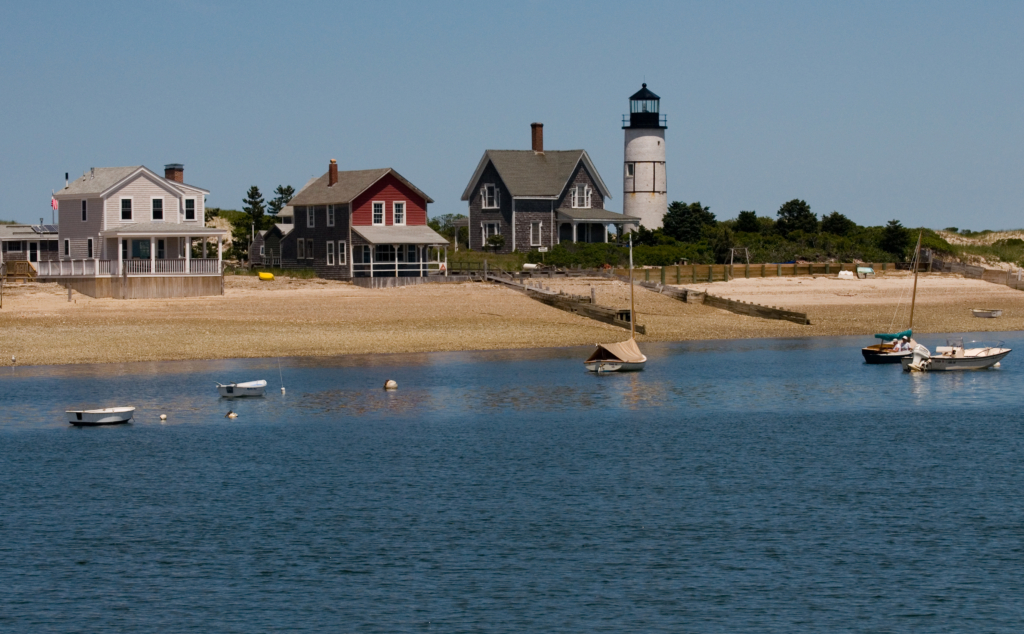 alt="Chatham Lighthouse on Cape Cod with blue sky and green grass in summer