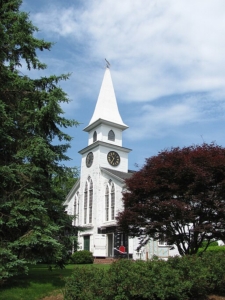 Classic white New England church building with steeple in Brewster, MA