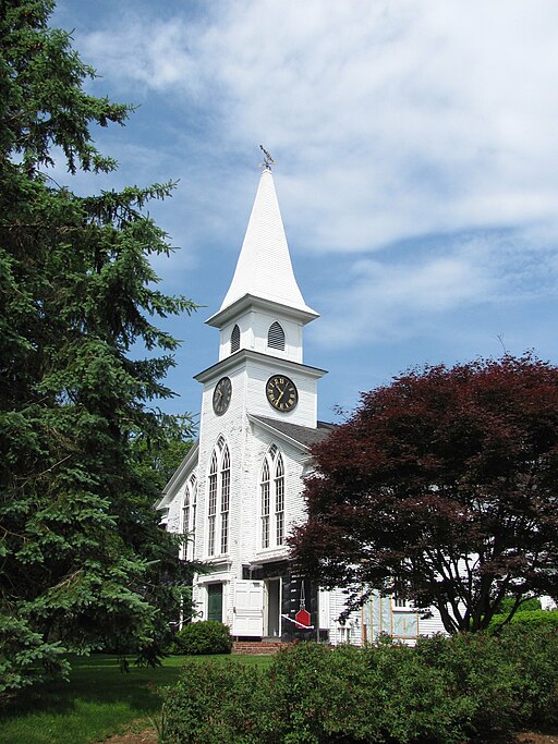 Classic white New England church building with steeple in Brewster, MA